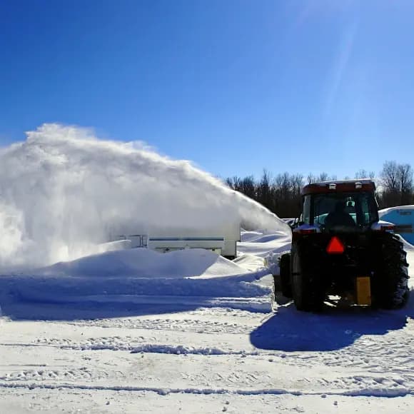 man plowing snow with a snowblower